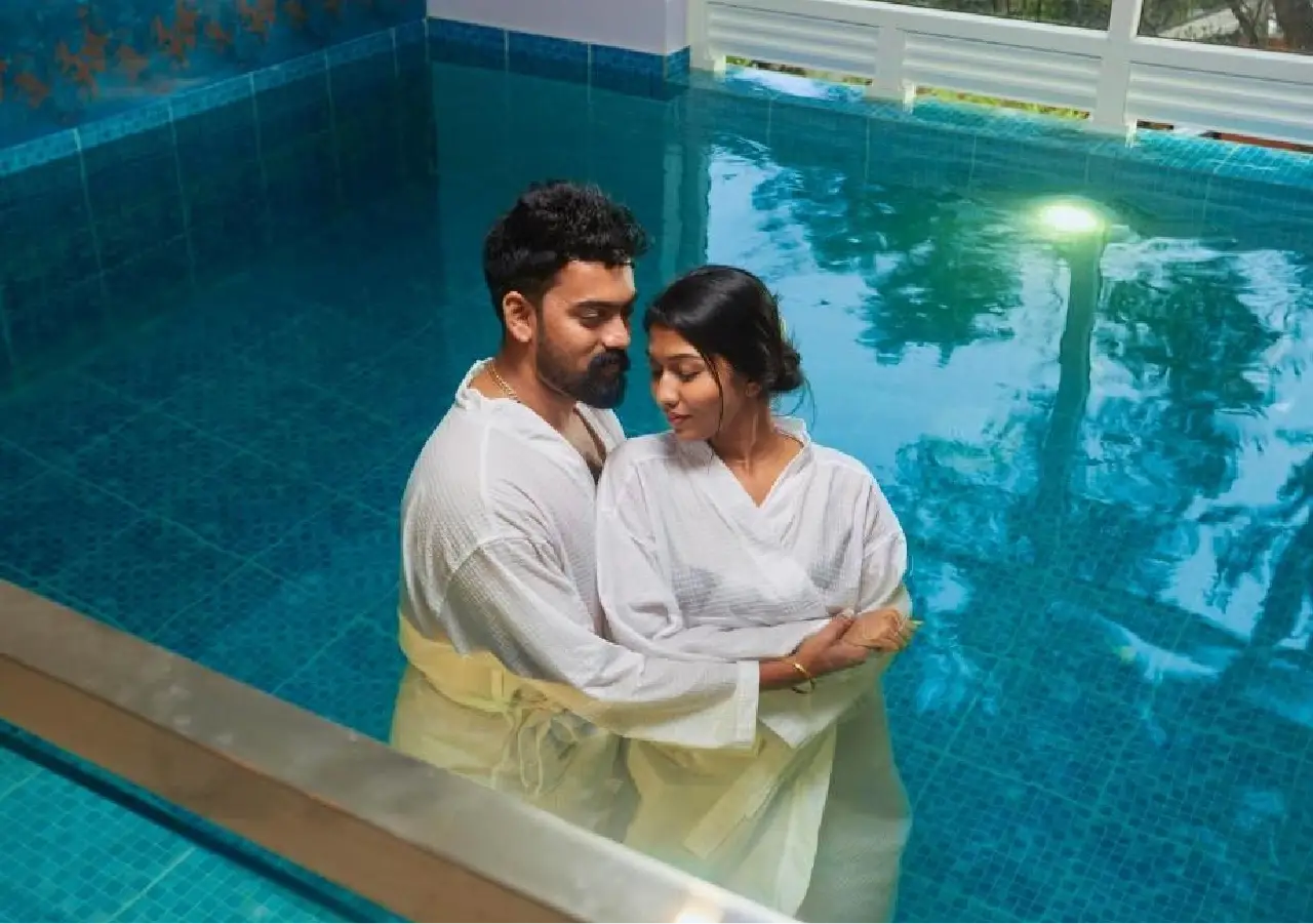 Couple Enjoying Honeymoon in a pool resort at Munnar Honeymoon Holidays - Travelmojo Holidays
