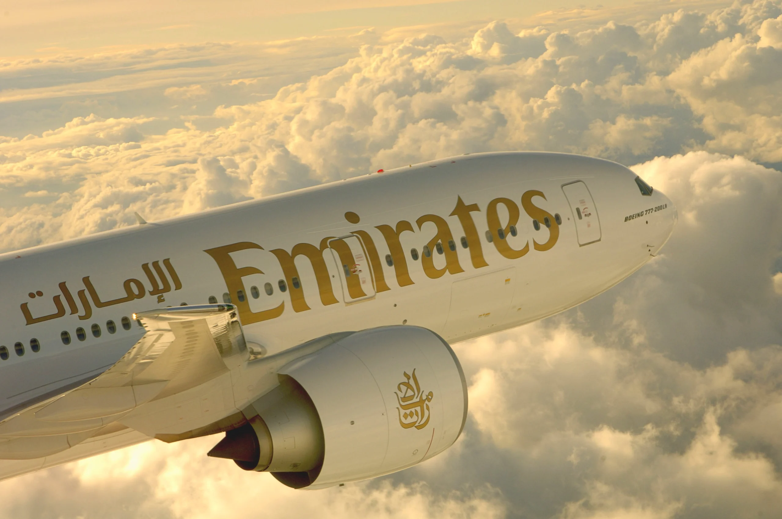 Emirates Airlines Plane at the Skies on a golden evening lights- High Quality Image